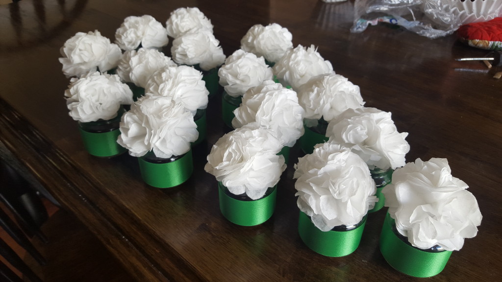 Coffee filter flowers in vases with green ribbon and wrap.  