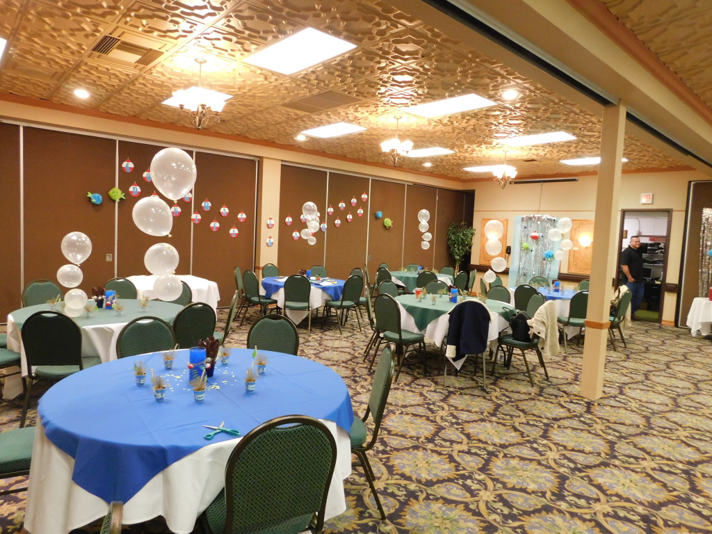 tables with bubbles and colored tablecloths for the baby shower for the boss.