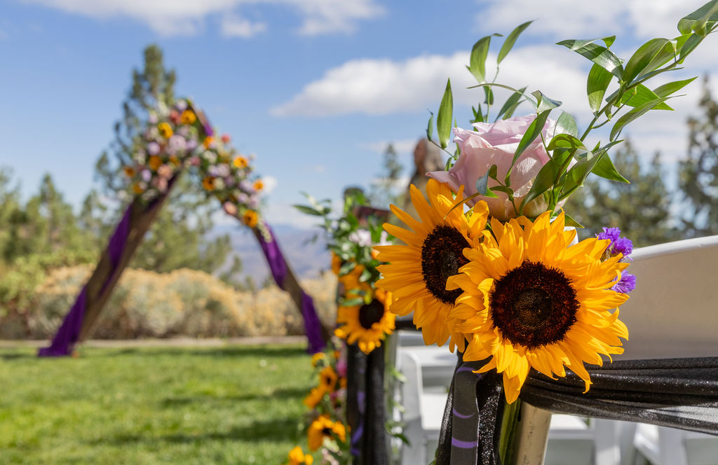 Purple and gold wedding aisle decor with sunflowers at Tannenbaum Event Center