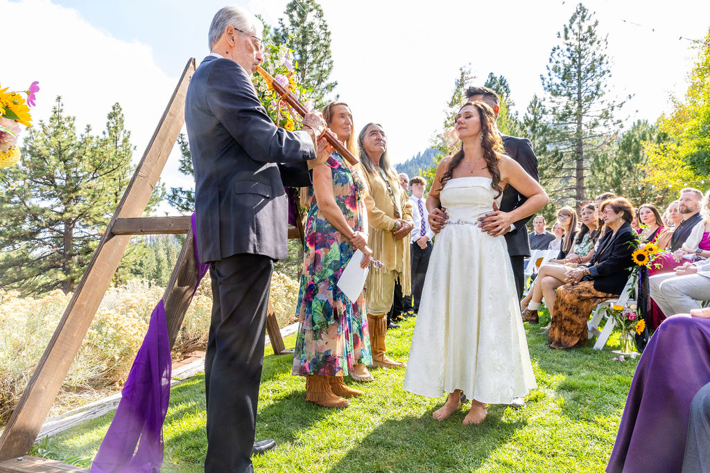 Father performing flute music during wedding ceremony at Tannenbaum Event Center
